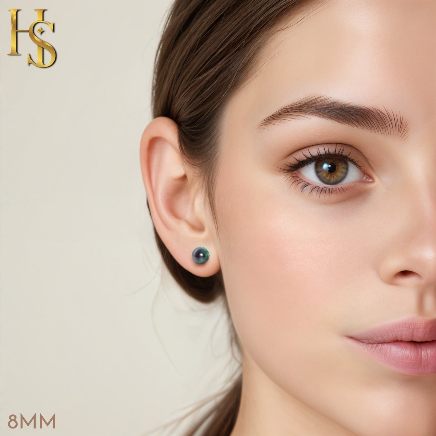 A round, iridescent abalone pearl stud earring in sterling silver worn on the ear.