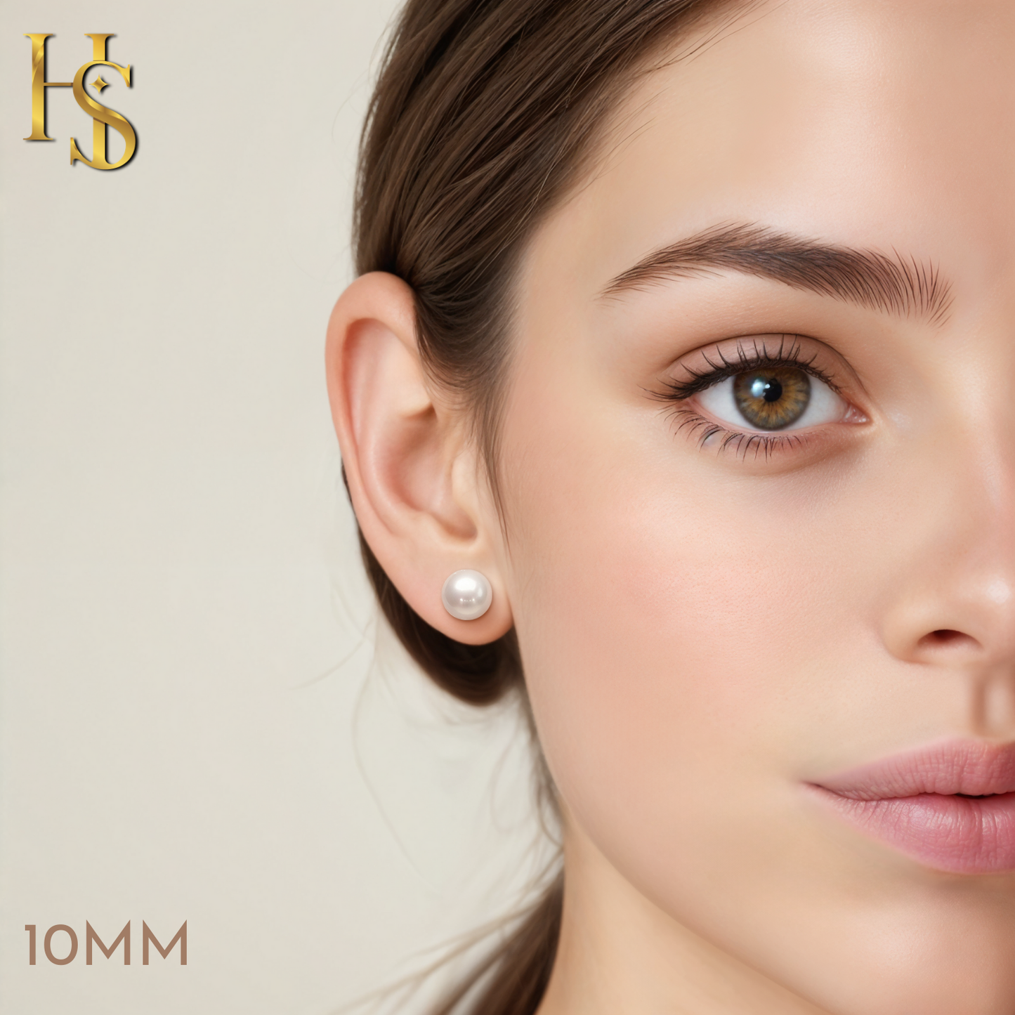 A classic round white pearl stud earring in a sterling silver setting, worn on a model's ear to show its 10mm size.