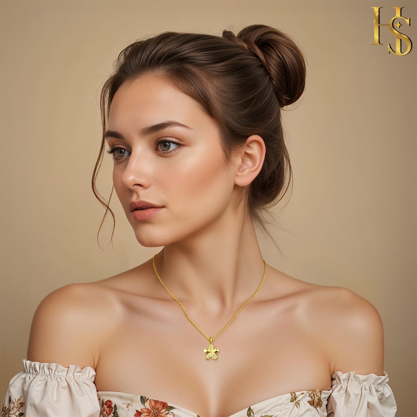 A gold-plated sterling silver pendant necklace with a five-petal flower paved with American diamonds, worn on the neck by a model.