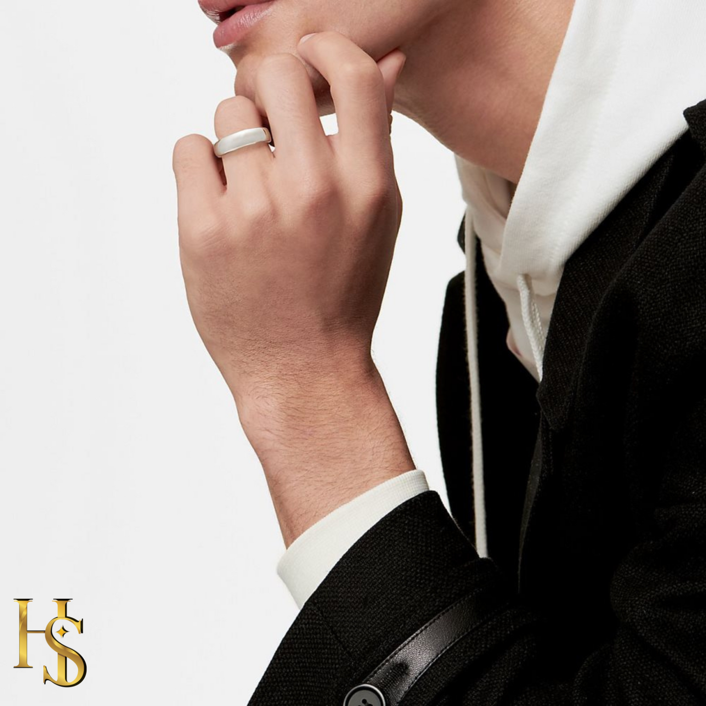 A classic wide band ring in matte sterling silver worn on a man's hand, styled with a black jacket and white hoodie.
