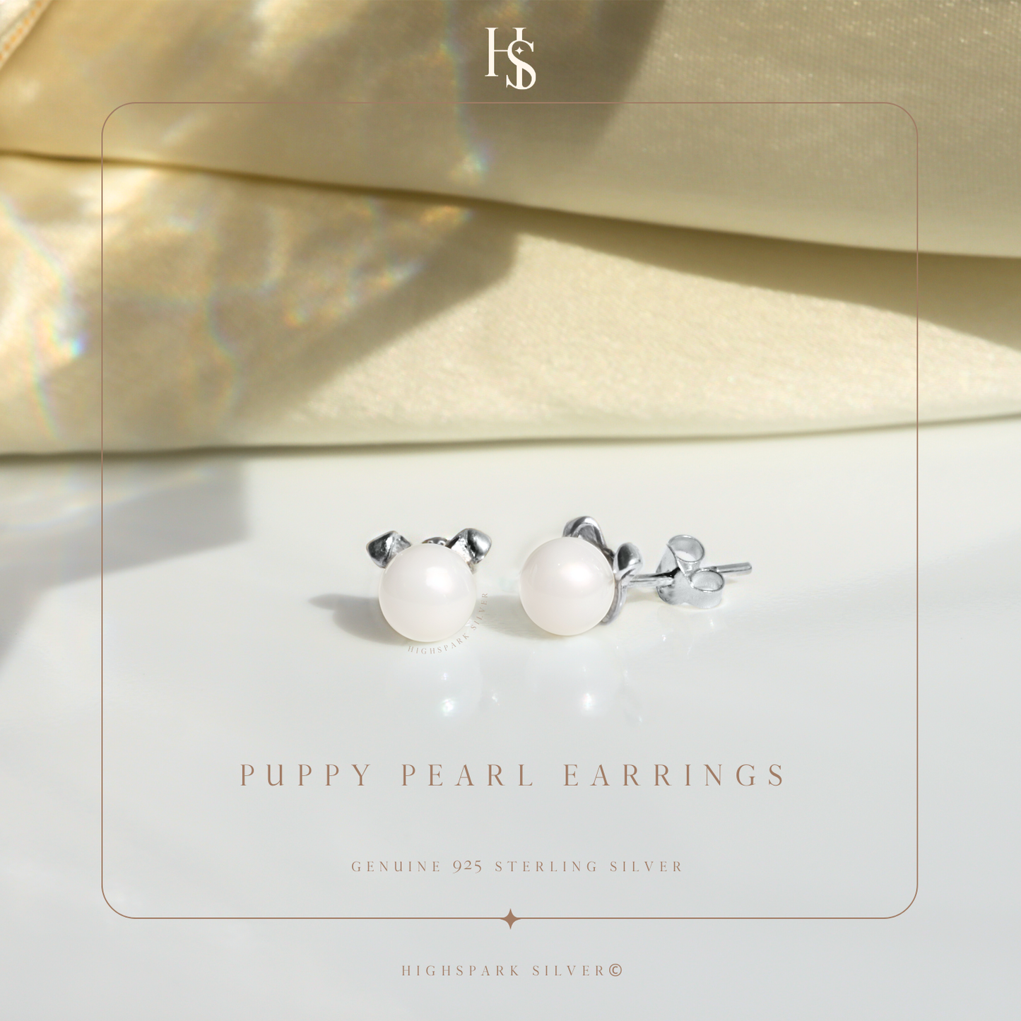 A pair of puppy-shaped stud earrings with freshwater pearl faces and sterling silver ears.