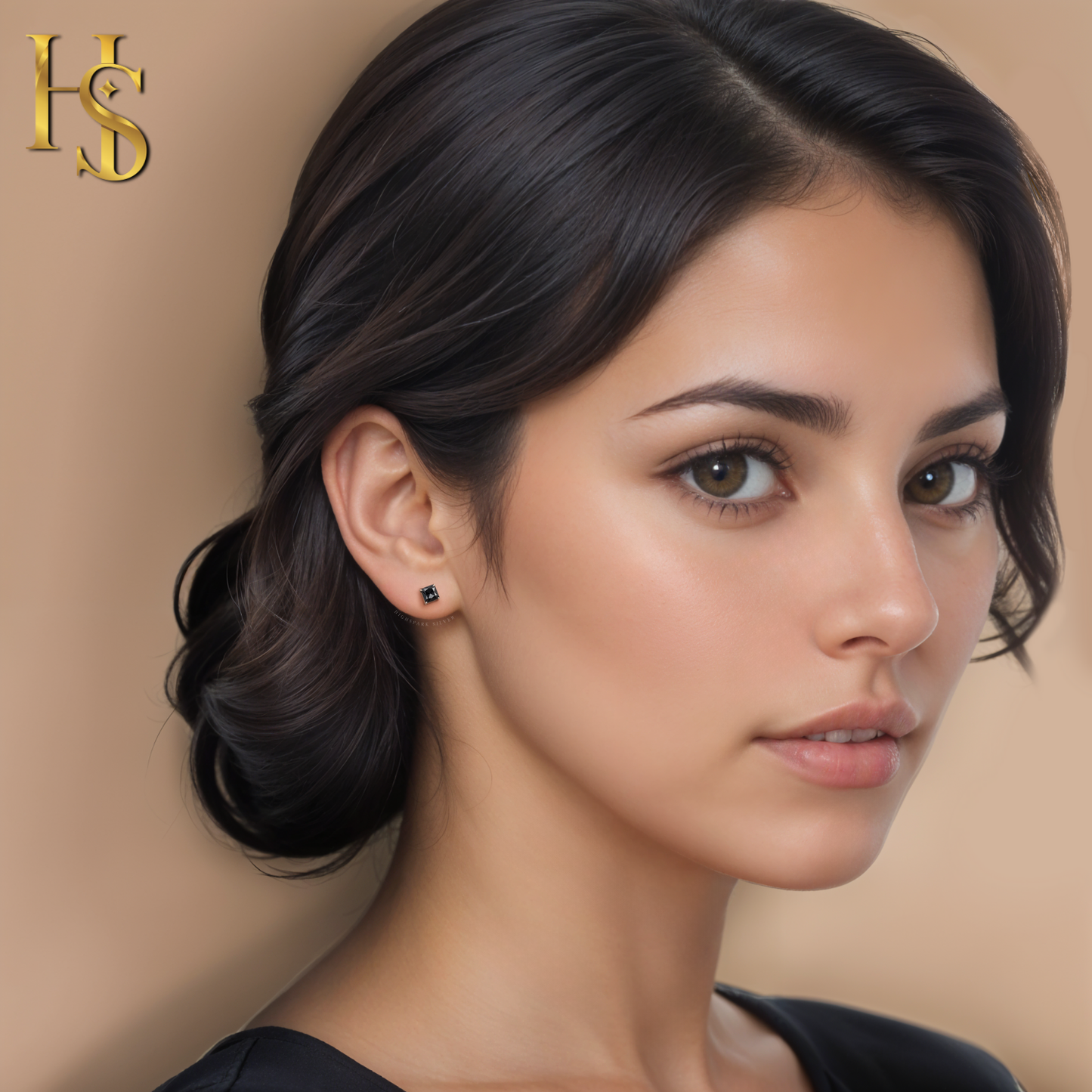 A small, square-cut black stone stud earring in sterling silver, worn on the ear by a model with her hair in an updo.