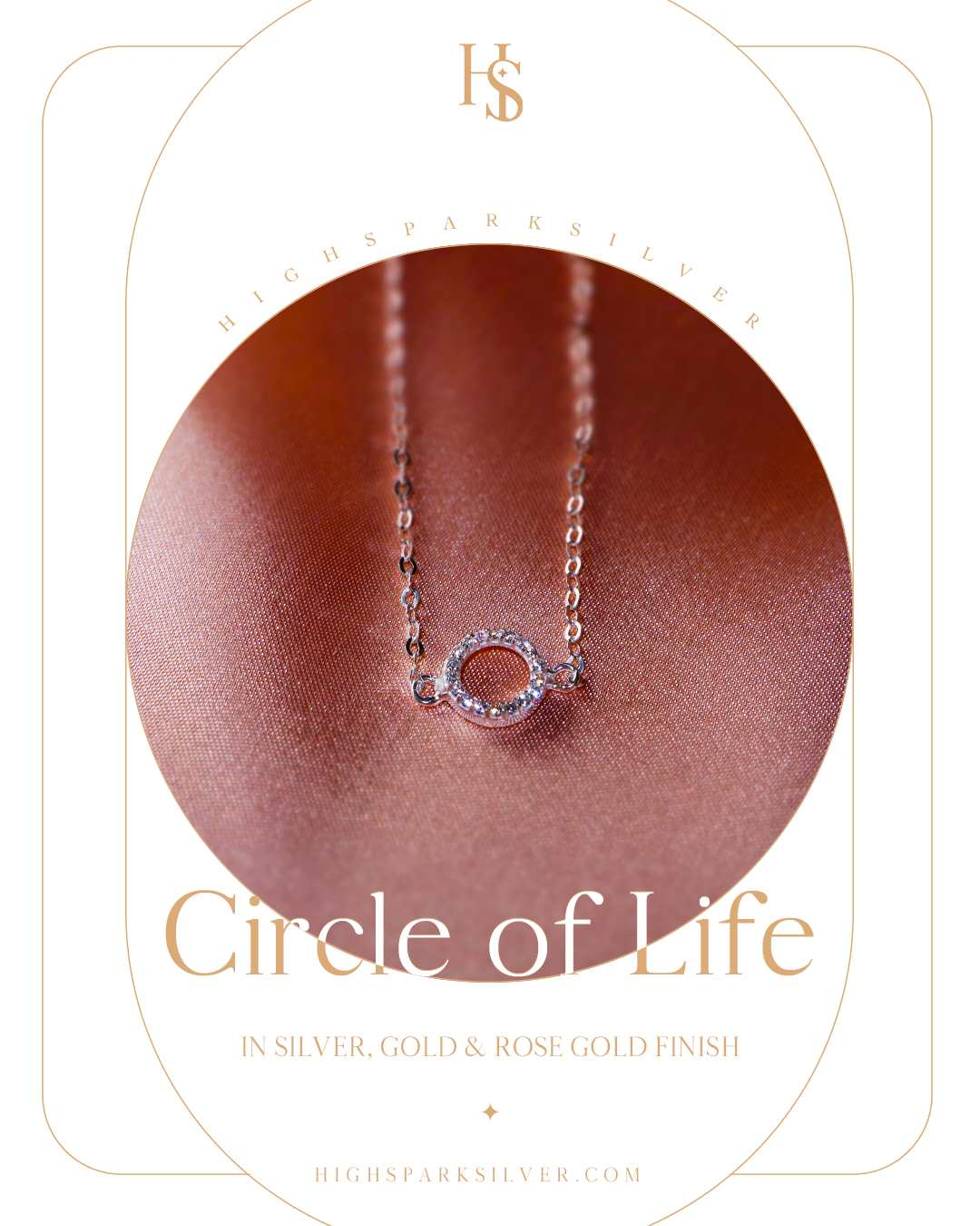 A sterling silver bracelet with a circular charm studded with American diamonds, styled on a soft rose-gold satin fabric.