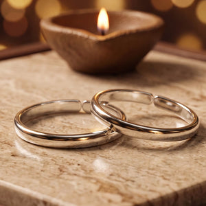 925 silver plain adjustable toe rings (bichiya) pair, beside a lit diya - toe rings category