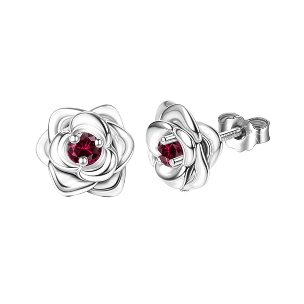 A pair of sterling silver stud earrings shaped like roses with a round red gemstone in a four-prong setting at the center.