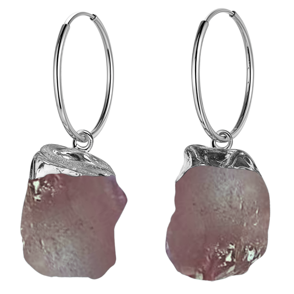 A pair of sterling silver hoop earrings with dangling raw-cut, irregular pink strawberry quartz gemstones in a molten silver setting.