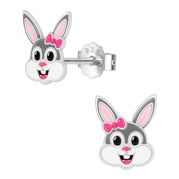 A pair of sterling silver stud earrings shaped like a cartoon bunny face with grey, white, and pink enamel and a push-back closure.