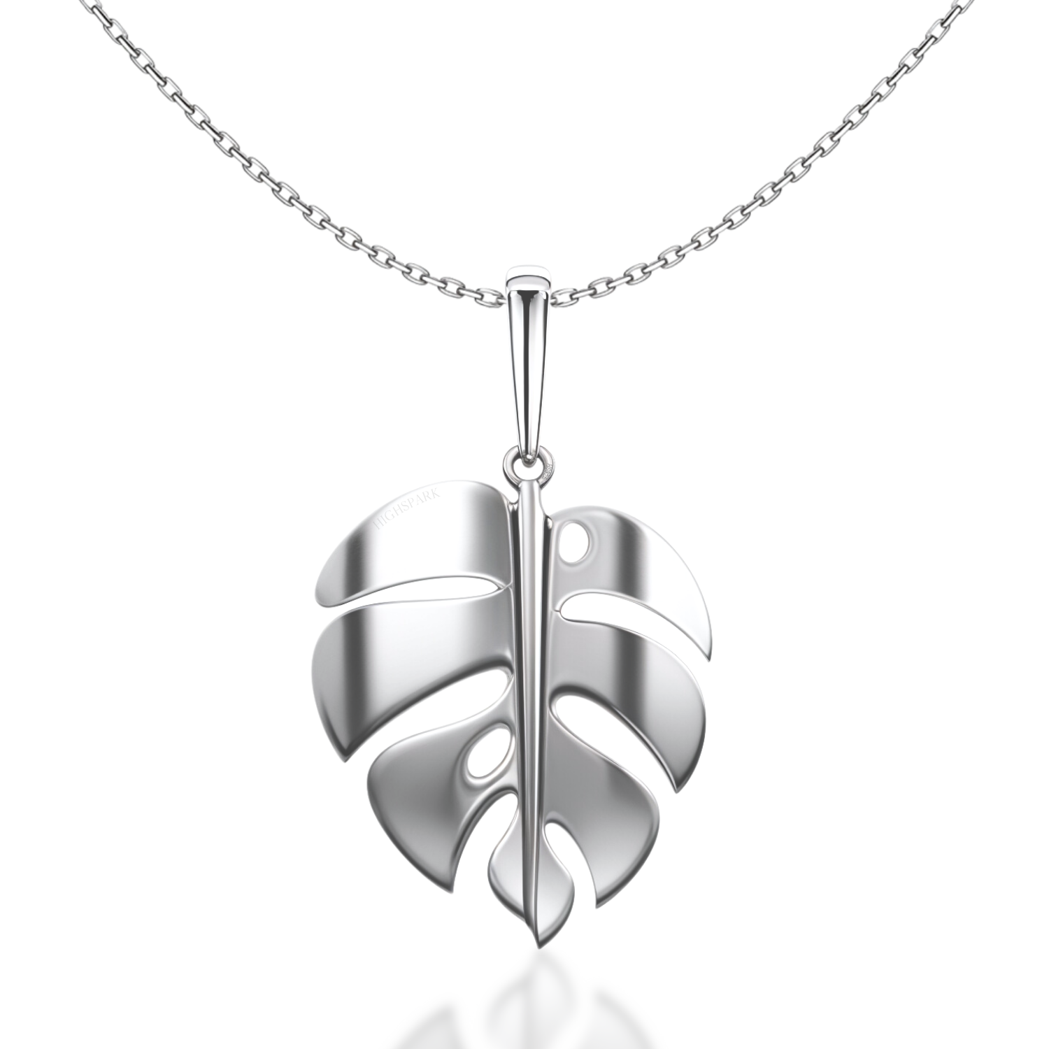 A sterling silver pendant necklace featuring a polished monstera leaf design on a delicate chain, shown on a white reflective surface.