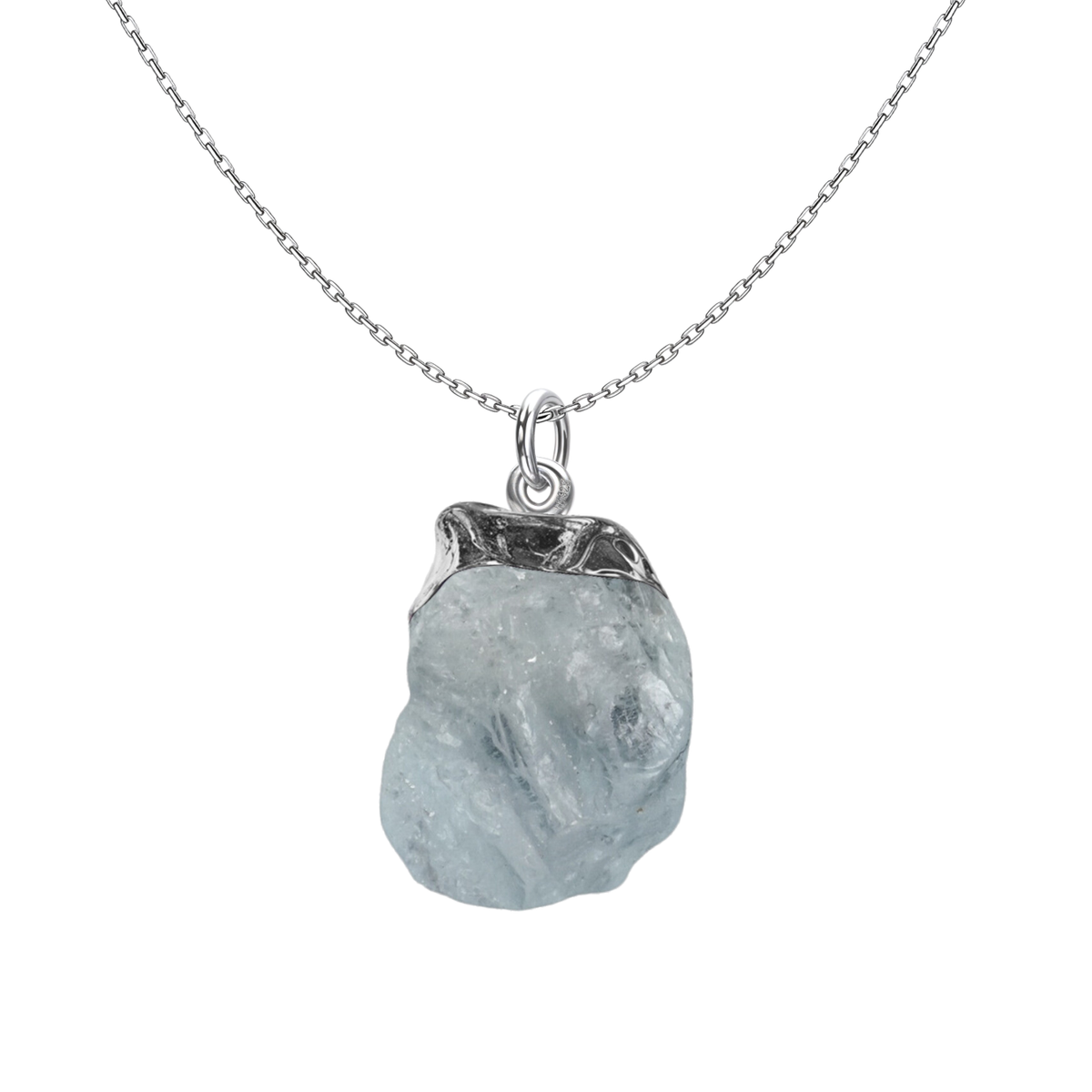A sterling silver pendant necklace featuring a rough-cut, pale blue aquamarine gemstone in a cap setting on a plain white background.
