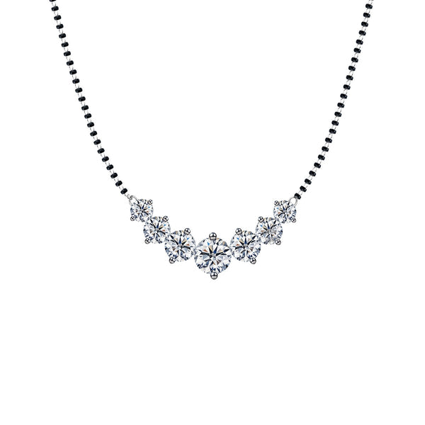 A sterling silver mangalsutra necklace for women with seven round American diamonds in a prong-set curved pendant on a black beaded chain.