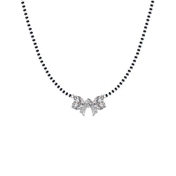 A sterling silver mangalsutra necklace with a bow-shaped pendant set with American diamonds on a traditional black beaded chain.