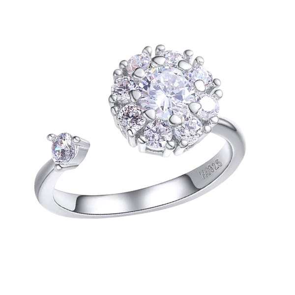 An adjustable sterling silver ring with a sunflower-shaped halo of American diamonds and a single stone on the open band.