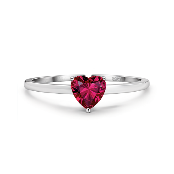 A sterling silver ring featuring a single, heart-shaped red gemstone held in a three-prong setting on a plain white background.