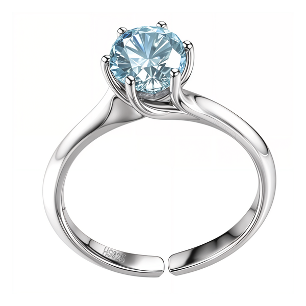 An adjustable solitaire ring with a round aquamarine American diamond in a six-prong setting on a polished sterling silver band.