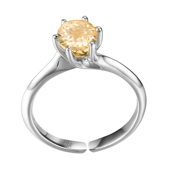 An adjustable solitaire ring with a round, faceted citrine gemstone in a six-prong setting on a sterling silver band.