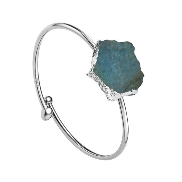 An adjustable cuff bracelet with a large, rough-cut labradorite gemstone in a sterling silver setting on a plain white background.