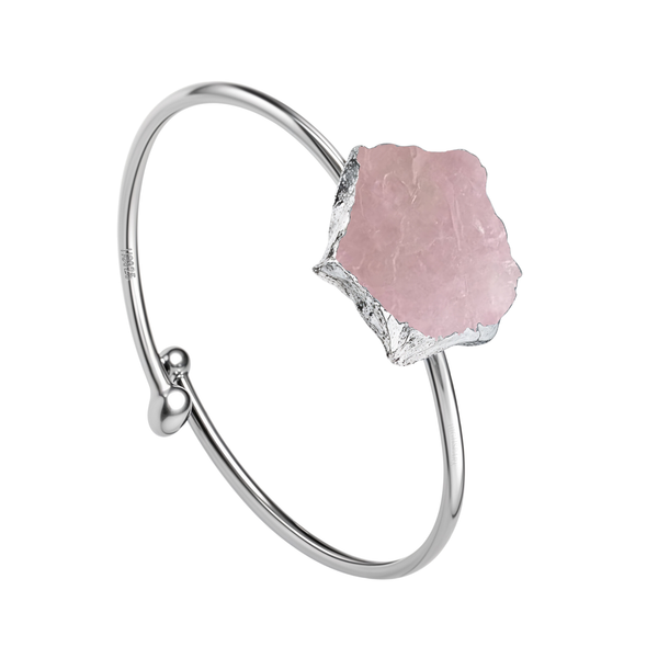 An adjustable sterling silver ring with a large, rough-cut raw rose quartz gemstone, shown on a plain white background.