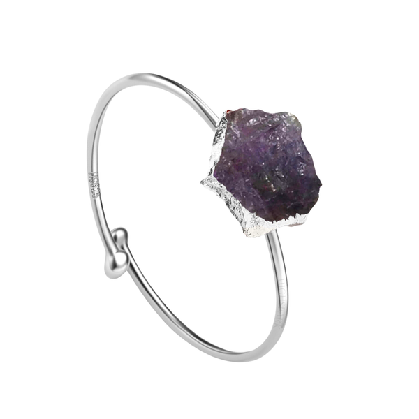 An adjustable sterling silver ring with a large, raw-cut purple amethyst gemstone on a simple bypass band.