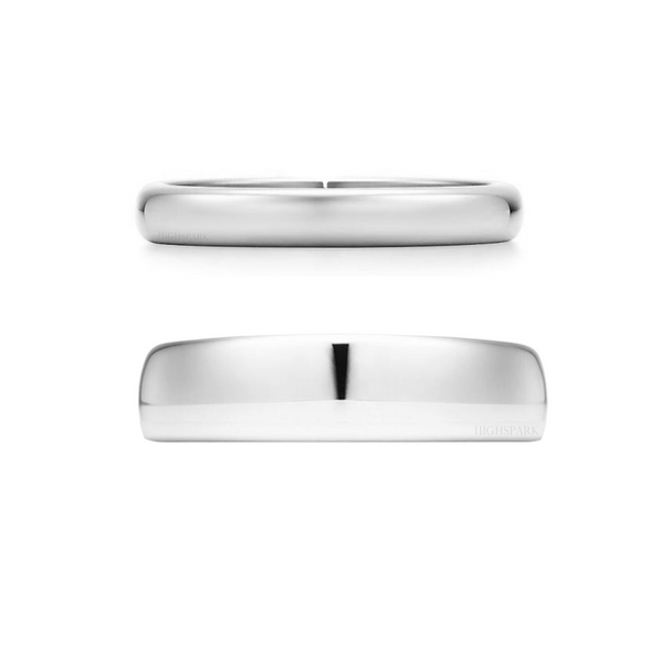 A pair of classic sterling silver band rings, one wider and one narrower, shown side-on against a plain white background.
