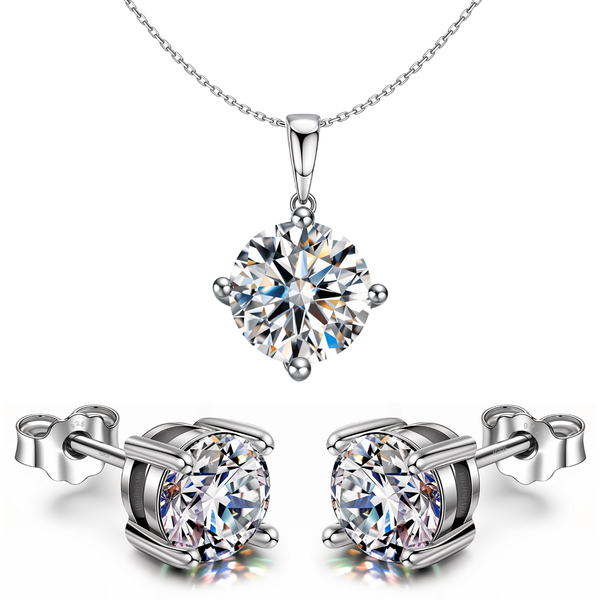 A sterling silver pendant necklace and stud earring set with round American diamonds in a four-prong setting, shown on a white background.