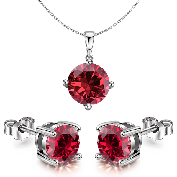 A sterling silver pendant and earring set with round, ruby-red stones held in a four-prong setting on a plain white background.