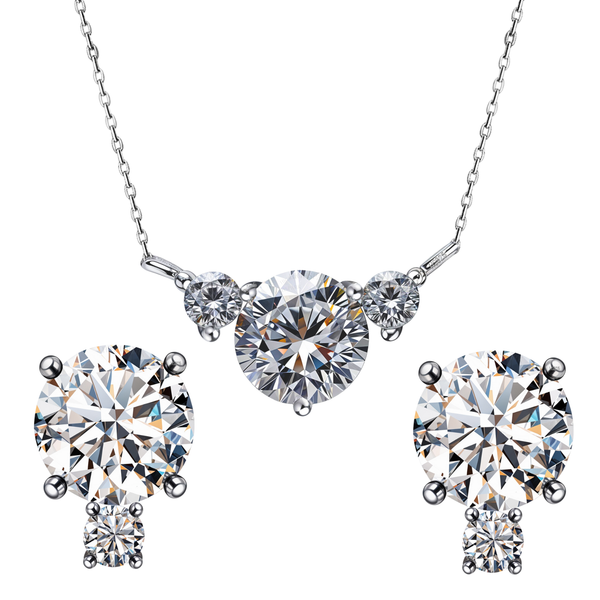 A sterling silver jewellery set with a three-stone American diamond pendant necklace and matching two-stone stud earrings on a white.
