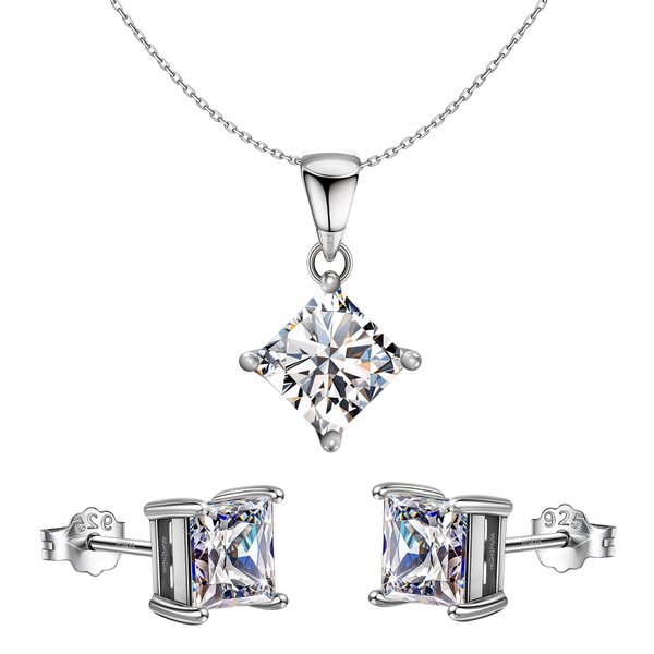A sterling silver jewellery set with a princess-cut American diamond pendant necklace and matching four-prong stud earrings on a white.