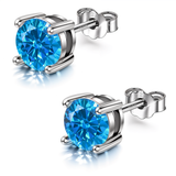 A pair of September birthstone silver earrings with round, brilliant-cut blue American diamonds in a four-prong sterling silver setting.