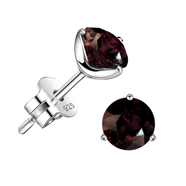 A pair of stud earrings with round, faceted garnet gemstones in a three-prong sterling silver setting on a white background.