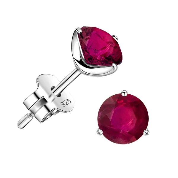 A pair of stud earrings with round-cut ruby gemstones in a three-prong sterling silver setting, shown on a white background.