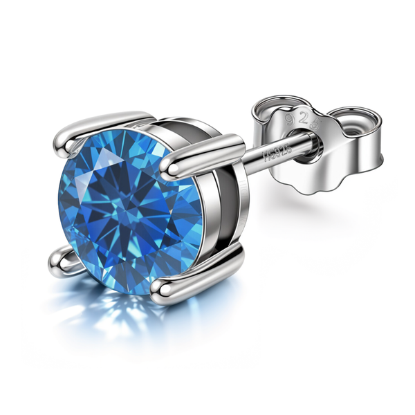 A men's solitaire stud earring with a round, brilliant-cut blue sapphire American diamond in a four-prong sterling silver setting.
