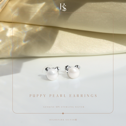 A pair of puppy-shaped stud earrings with freshwater pearl faces and sterling silver ears.