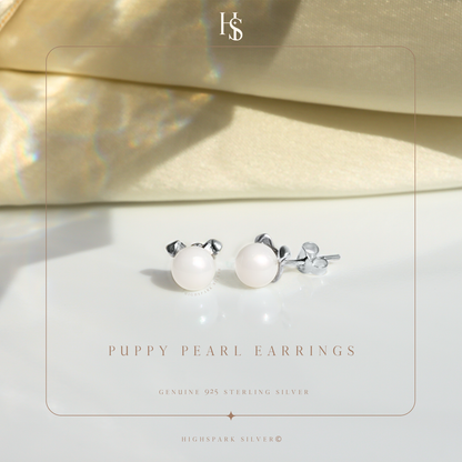 A pair of puppy-shaped stud earrings with freshwater pearl faces and sterling silver ears.