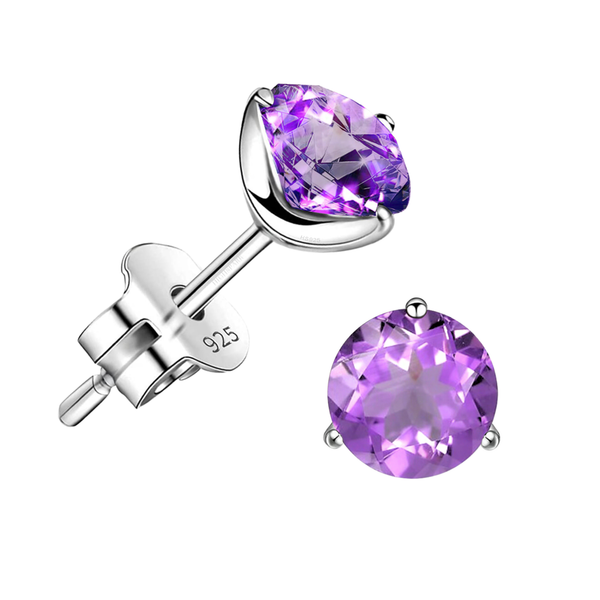 A pair of stud earrings with round, faceted amethyst gemstones in a three-prong sterling silver setting on a white background.