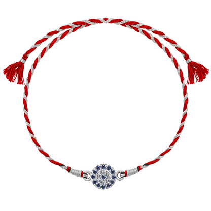 A 925 sterling silver rakhi for brother featuring a round evil eye motif with blue stones and American diamonds on a red and silver thread.