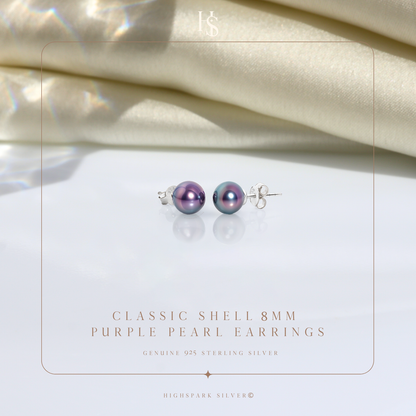 A pair of iridescent purple shell pearl stud earrings in sterling silver.