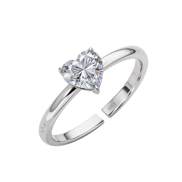 An adjustable sterling silver ring with a solitaire heart-shaped American diamond in a three-prong setting on a plain white background.