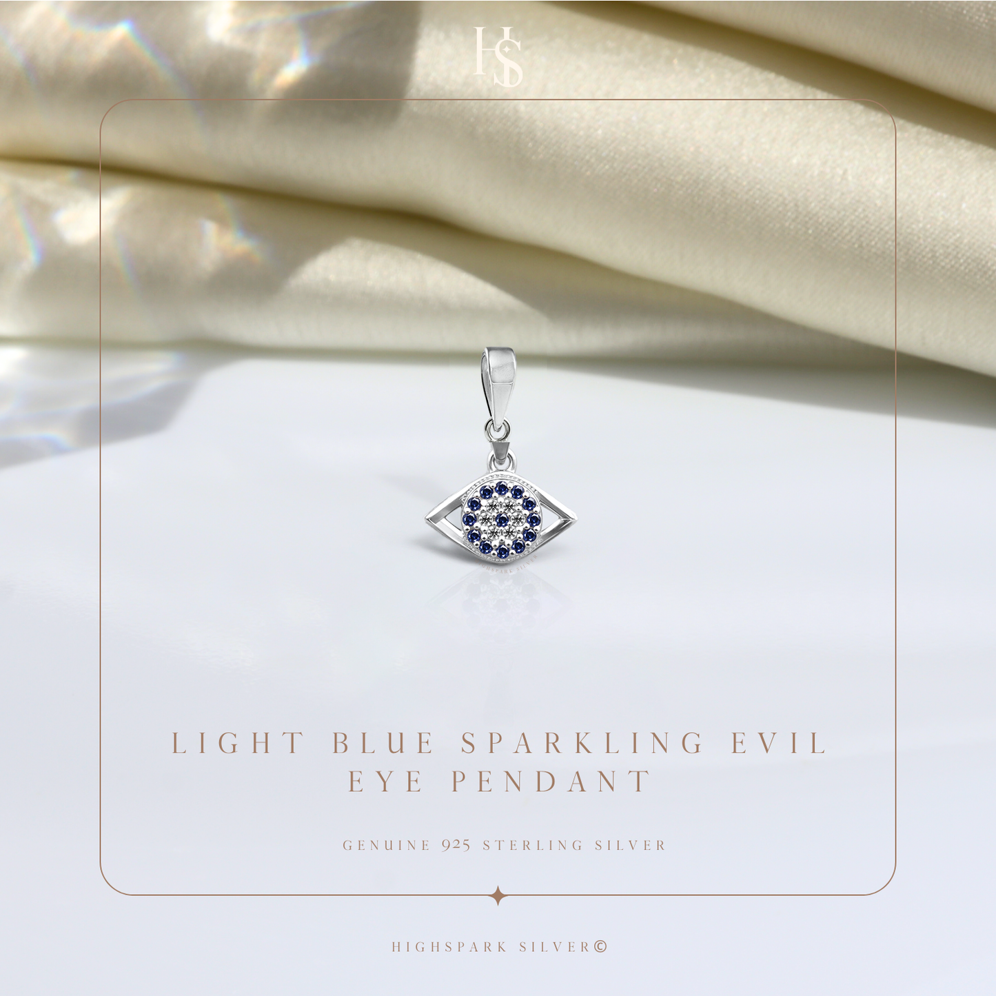 An evil eye pendant in sterling silver with a central cluster of American diamonds surrounded by blue stones.