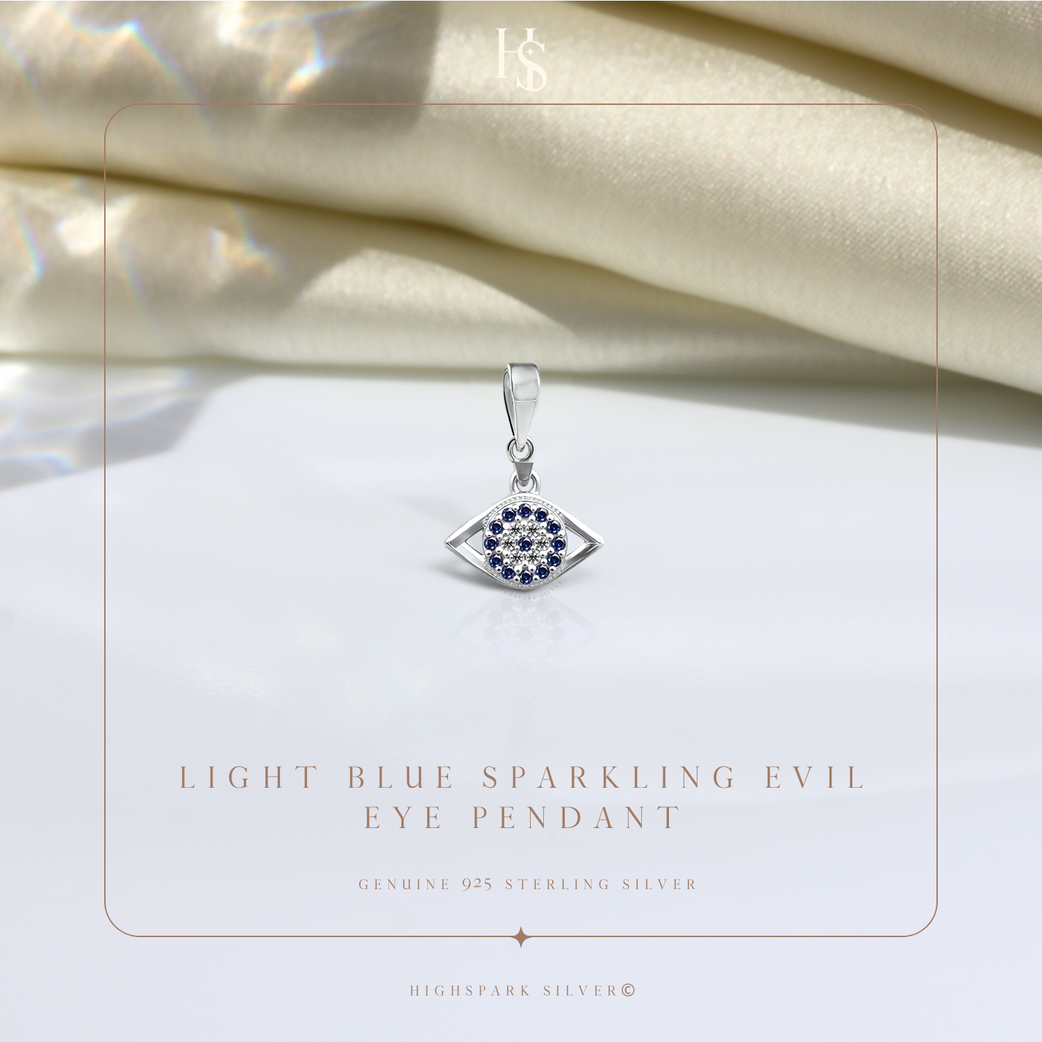 An evil eye pendant in sterling silver with a central cluster of American diamonds surrounded by blue stones.