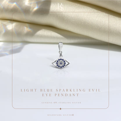 An evil eye pendant in sterling silver with a central cluster of American diamonds surrounded by blue stones.