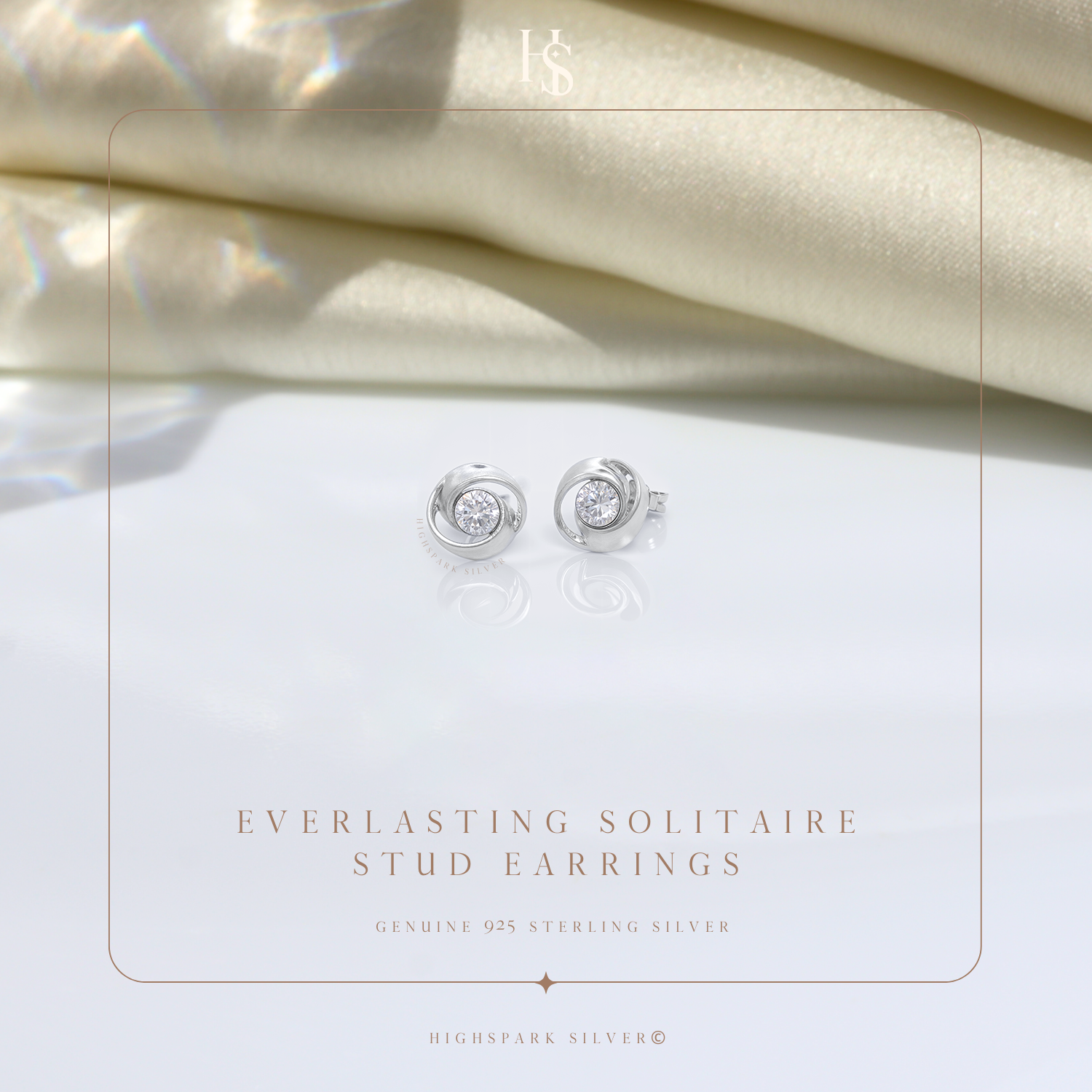 A pair of sterling silver stud earrings with a swirling design holding a central American diamond.