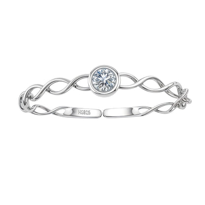 An adjustable sterling silver ring with an intertwined band and a central, bezel-set round American diamond on a white background.
