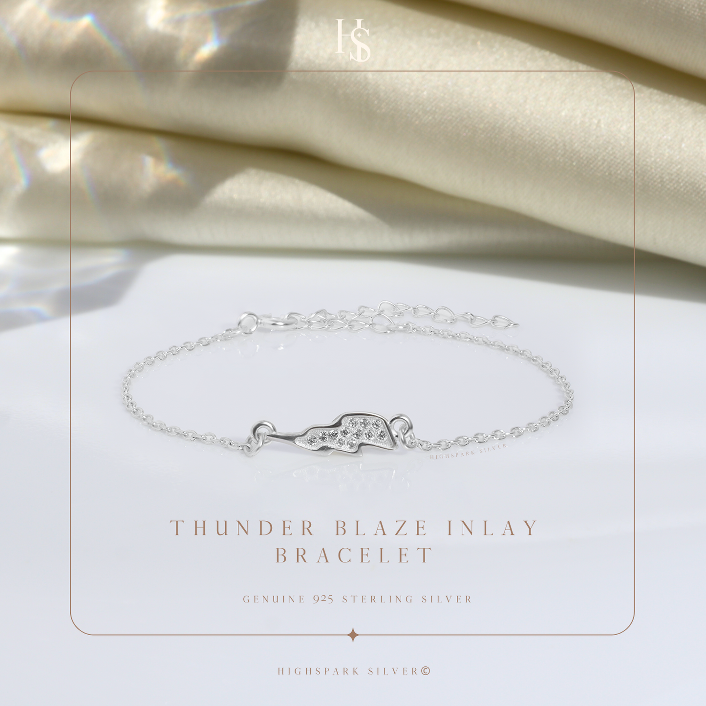 A sterling silver chain bracelet with a lightning bolt charm inlaid with American diamonds.
