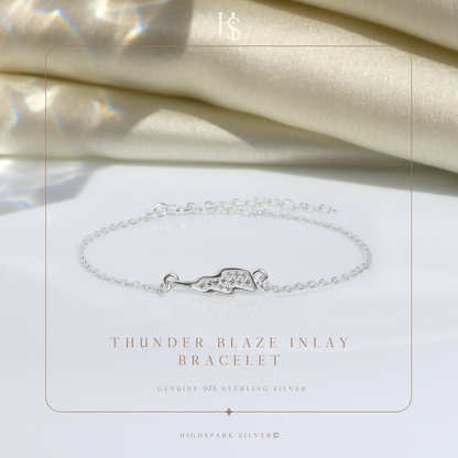 A sterling silver chain bracelet with a lightning bolt charm inlaid with American diamonds.