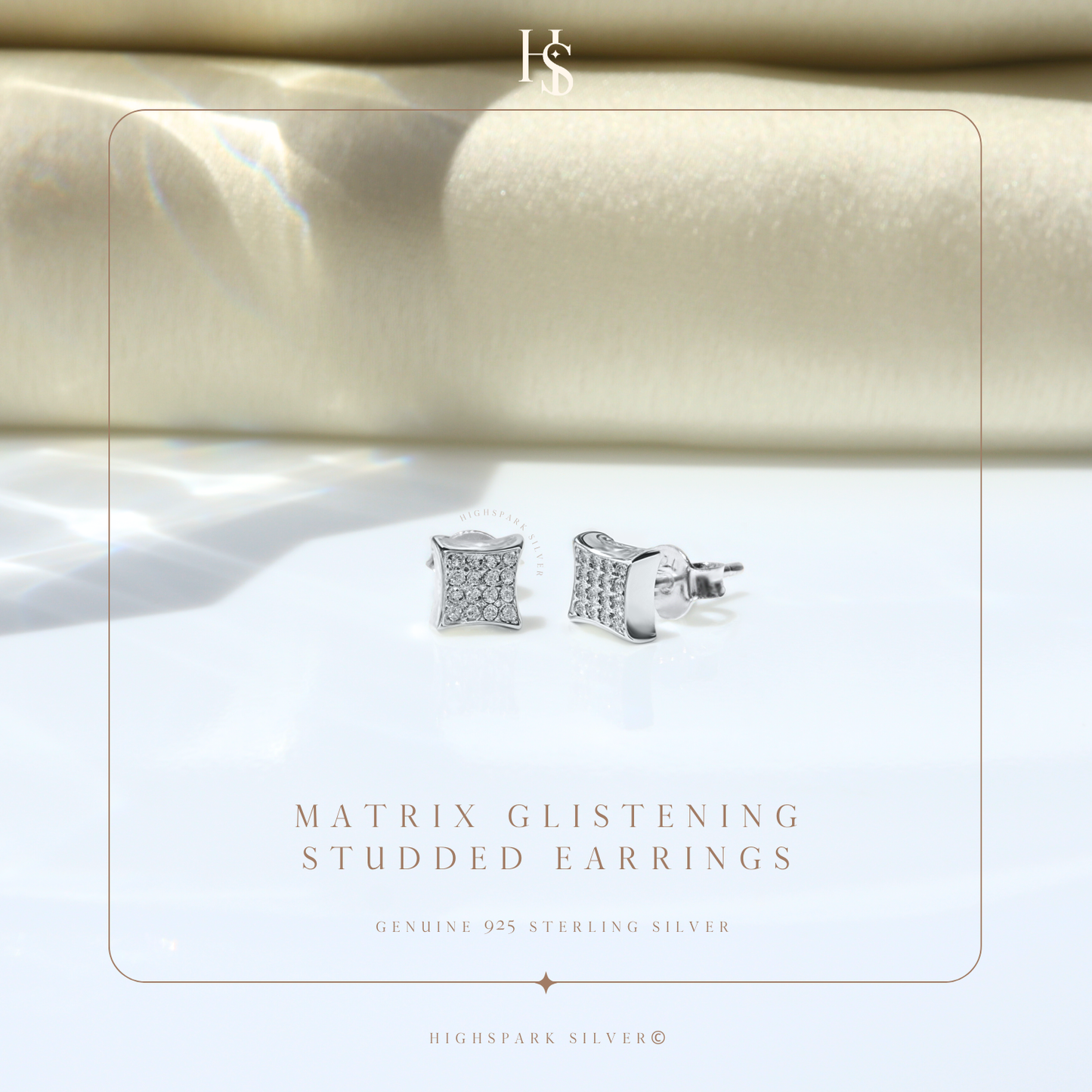 A pair of square stud earrings with pavé-set American diamonds in sterling silver.