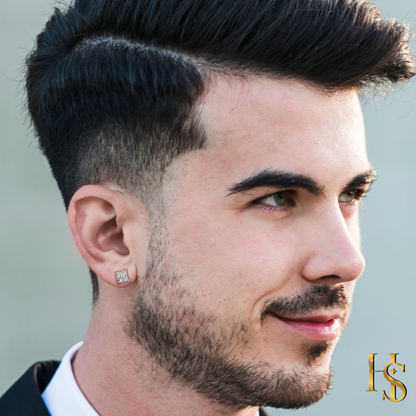A square sterling silver stud earring with a grid of princess-cut American diamonds worn on a man's ear.