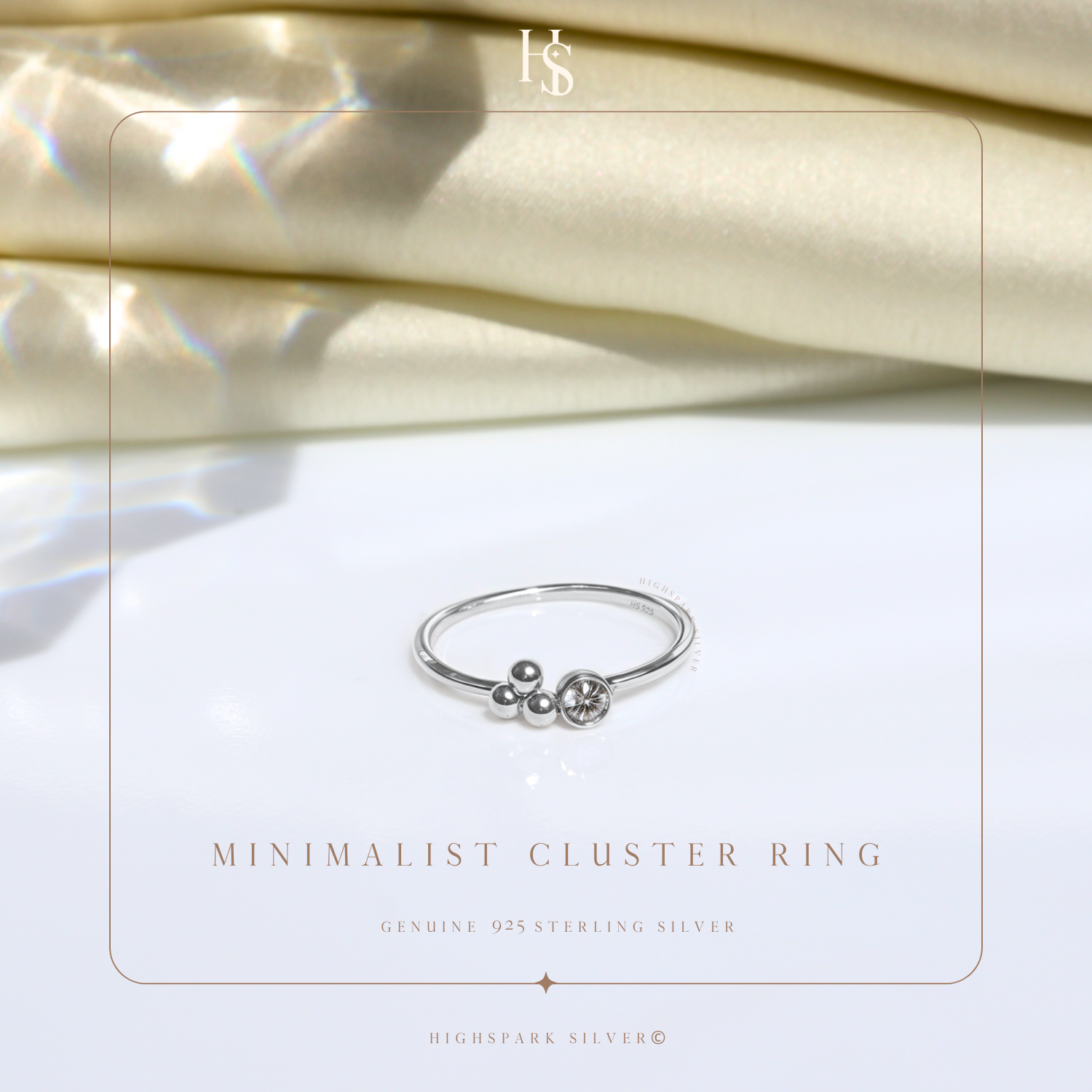 A minimalist sterling silver ring with a cluster of silver beads and a single bezel-set American diamond.