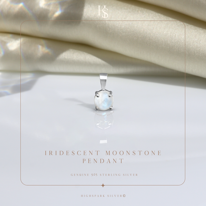 A sterling silver pendant with a round, iridescent moonstone in a four-prong setting.