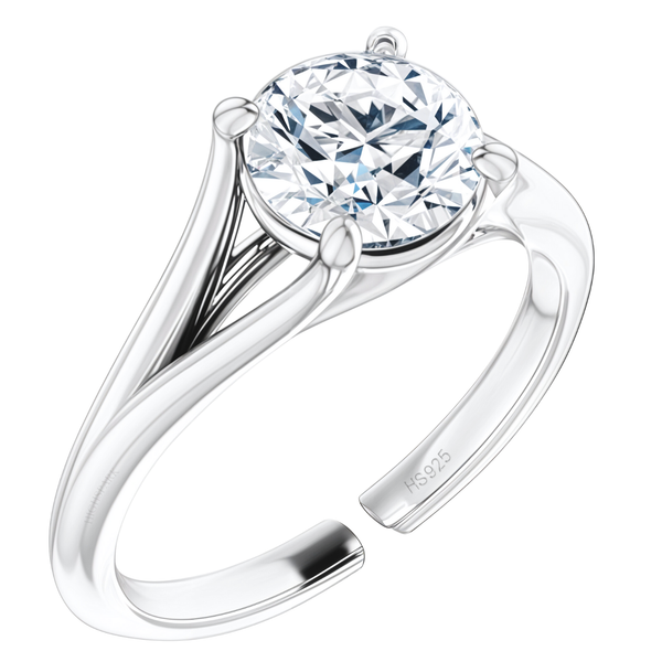An adjustable solitaire ring with a round American diamond in a four-prong setting on a split shank sterling silver band.