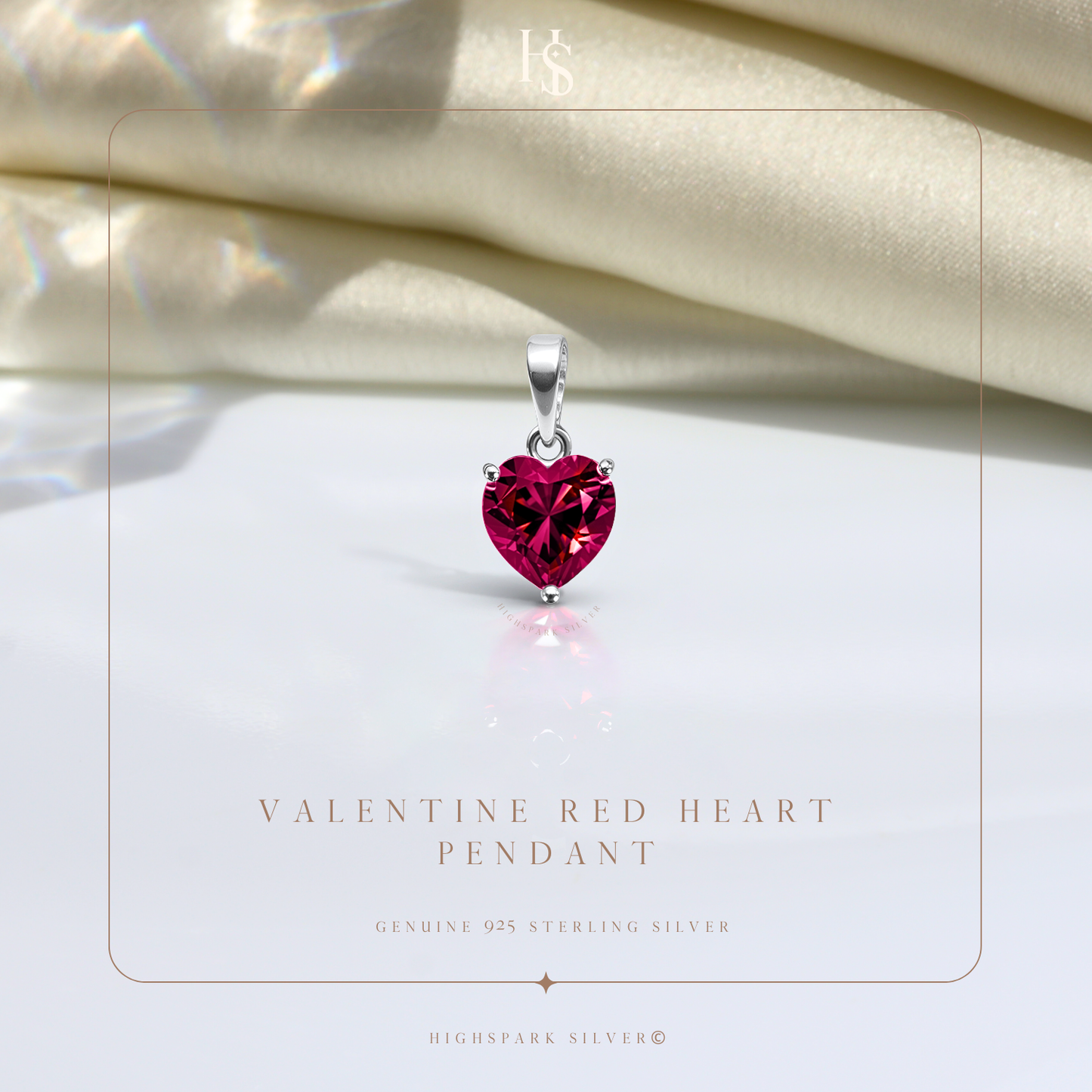 A sterling silver pendant with a faceted, heart-shaped red stone in a three-prong setting.